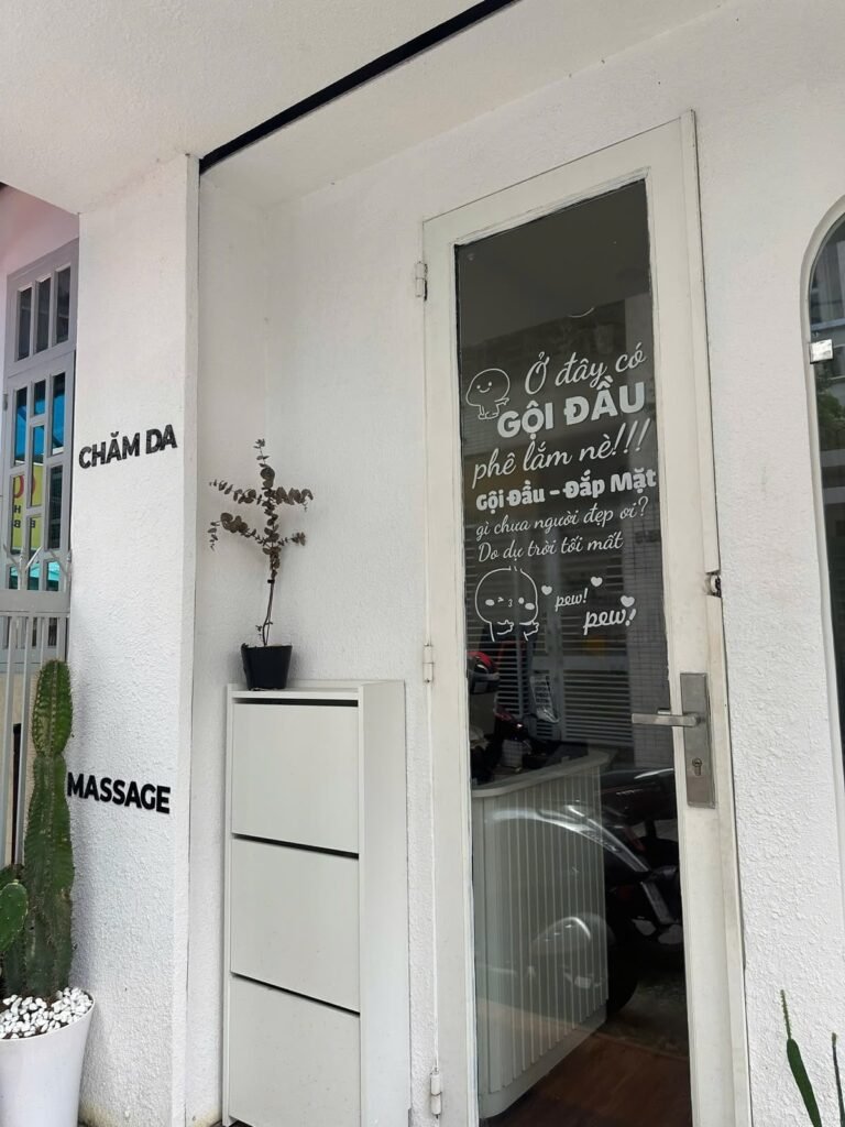 The entrance at Chạm Spa with gội đầu, chăm da and massage lettering beside the door