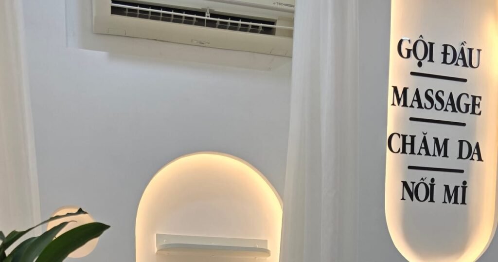 A Vietnamese spa service board listing gội đầu, massage, chăm da and nối mi