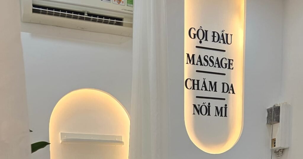 Vietnamese spa signage listing gội đầu, massage, chăm da and nối mi services