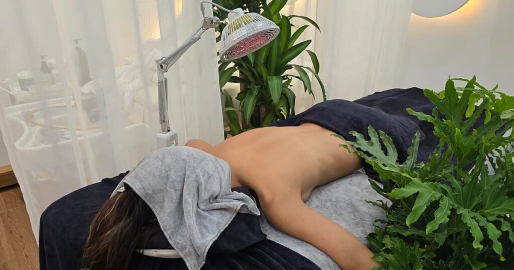A client lying face down under a towel, draped and ready for a back massage
